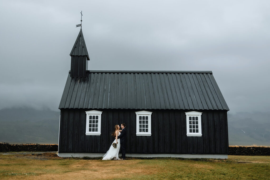 Kimberly and Blake outside the black church in Búðir, Iceland