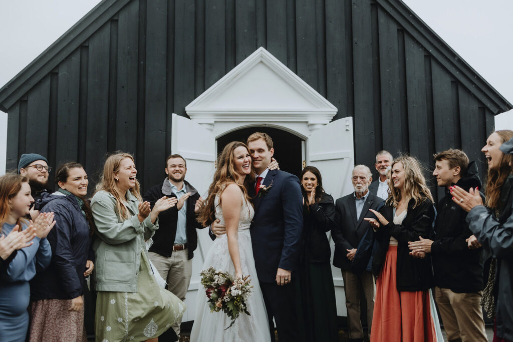 Wedding guests outside the black church in Búðir