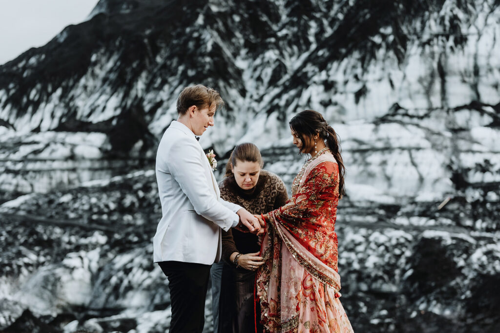 Handfasting cord tied around Mauli and Christian's hands on a glacier in Iceland 