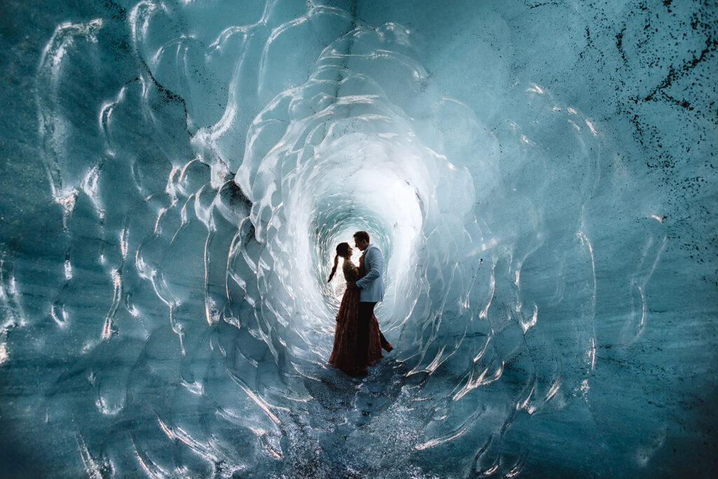 Mauli and Christian inside the blue Katla ice cave in Iceland, International Wedding Photographer of the Year 2024 Grand Prize winning photo