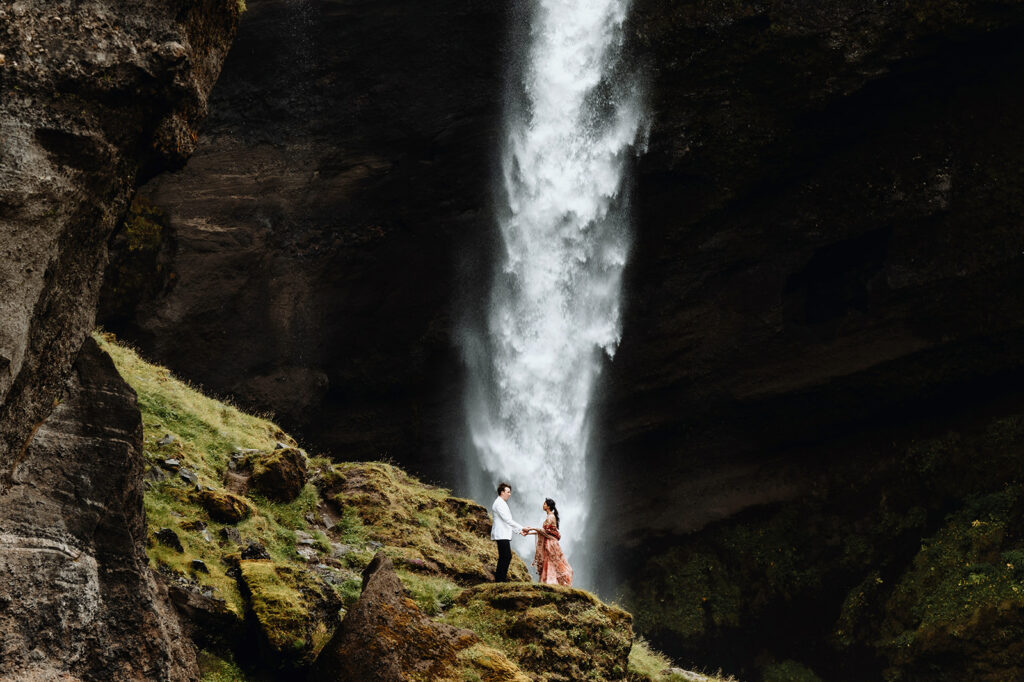 Mauli and Christian laughing in front of Seljalandsfoss waterfall