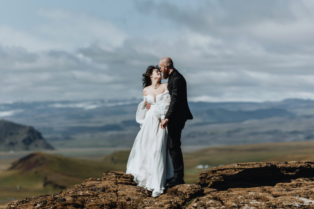 Jade and Bradley hugging at Dyrhólaey, Iceland