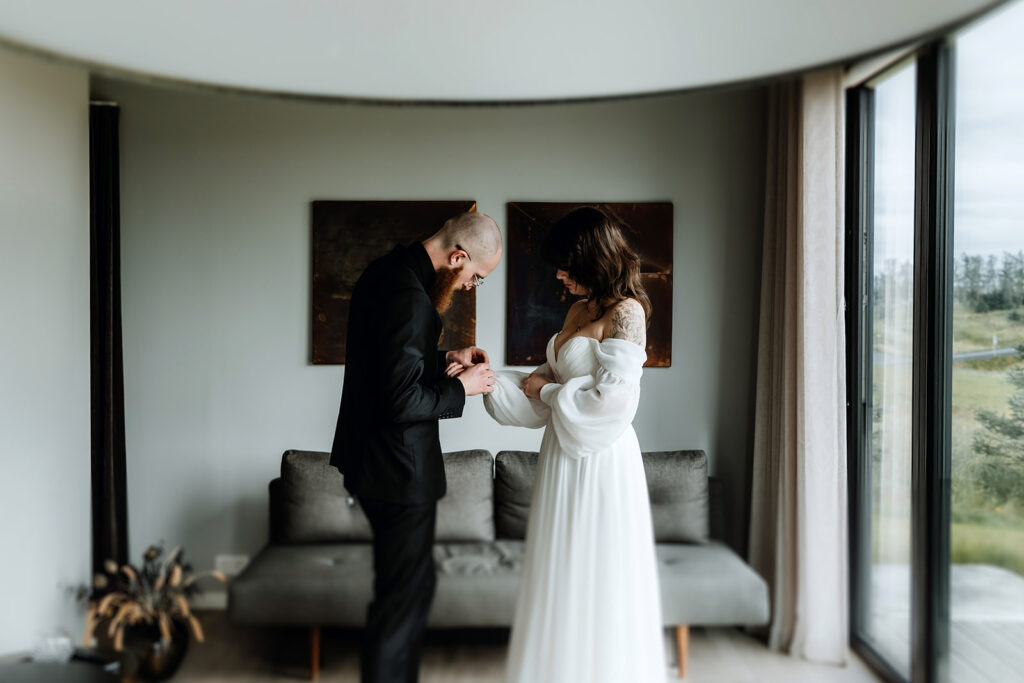 Bradley is helping Jade his bride to get dressed for their Icelandic elopement