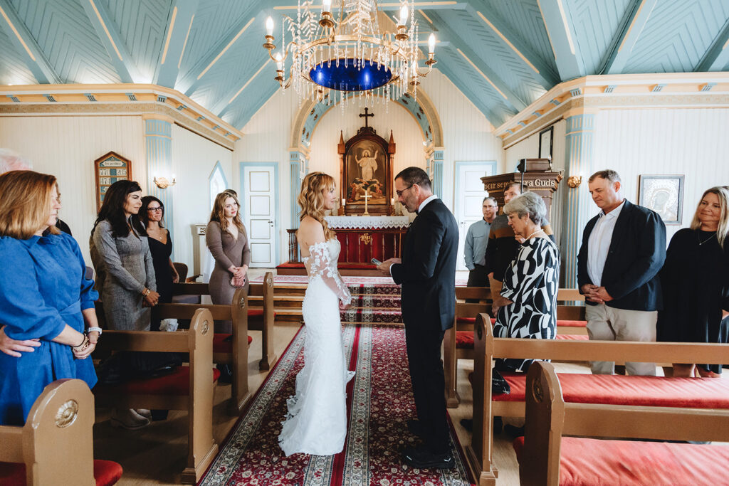 Tracie and Jay exchanging vows in the middle of Breiðabólstaðarkirkja church in Fljótshlíð